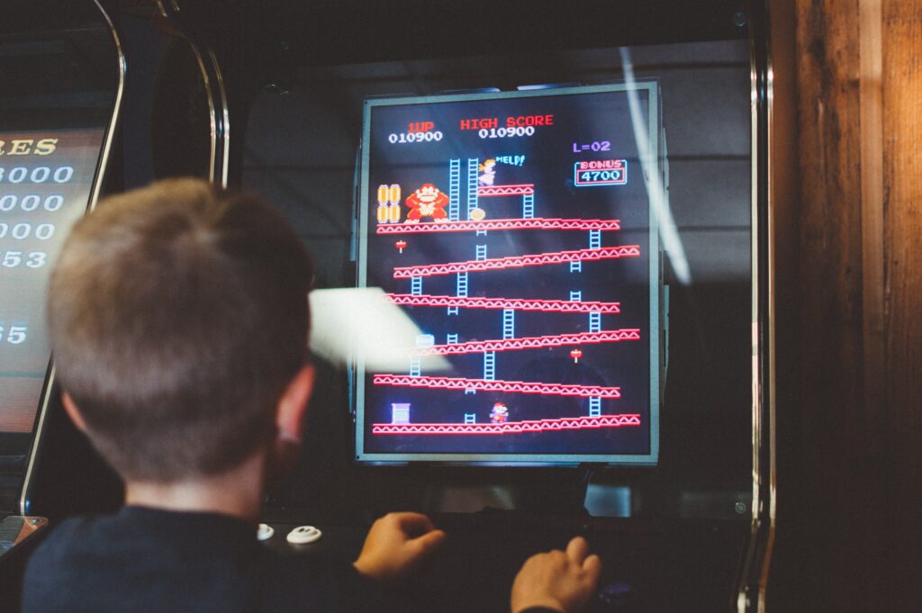 A young boy plays the original Donkey Kong Arcade Machine